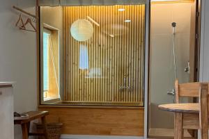 a bathroom with a shower with a glass door at 이도스테이 in Sinch'ang-ni