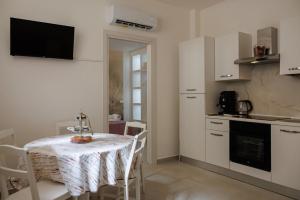 a small kitchen with a table and a table and chairs at B Luxury Home in Castellammare di Stabia +10 photos