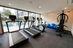 a gym with two treadmills and two exercise bikes at Ozone Sky View Residence in Laguna Phuket