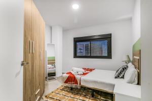 ベシンダリオにあるCity Hub Stayのベッドと窓のある白い寝室