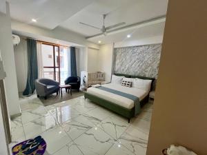 a bedroom with a king sized bed and a chair at Seabreeze haven apartment in Mombasa +32 photos