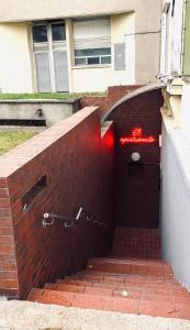 a brick wall with a red sign on it at 69 apartaments BDSM in Panevėžys