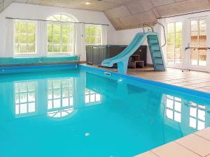 a swimming pool with a slide in a house at 18 person holiday home in Ulfborg in Ulfborg +32 photos