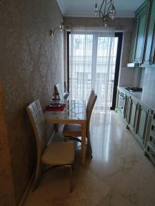 a dining room table and chairs in a kitchen at Modern Comfort in Old Tbilisi in Tbilisi City