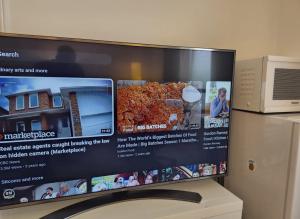 a computer monitor sitting on top of a refrigerator at New Era Home in Ottawa