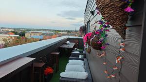 a balcony with chairs and flowers on a building at The Bridge in Dartford