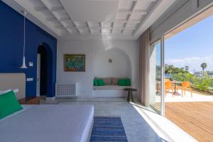 a bedroom with a bed and a balcony at Dar Elyssa in Sidi Bou Saïd