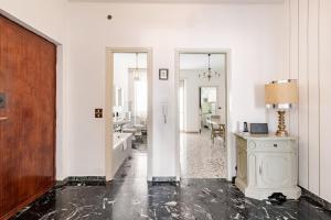 a white room with a hallway with a table and a desk at Casa Del Volo 10 Min Turin Airport & Juve Stadium in Borgaro Torinese +13 photos