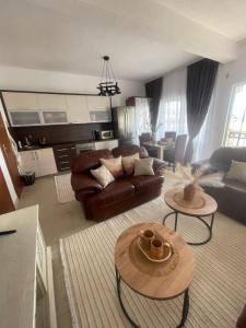 a living room with a couch and a table at Lux Apartman David Dobra voda in Bar