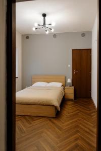 a bedroom with a bed and a ceiling fan at Stara słodownia in Grodków