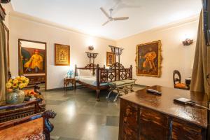 a room with a bed and paintings on the walls at The Royal Retreat Resort & Spa in Udaipur