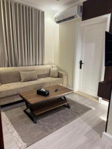 a living room with a couch and a coffee table at Luxurious studio with a modern design - Al Faisaliah neighborhood in Jeddah