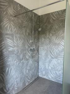 a bathroom with a shower with a leafy wall at Neubau FeWo in Haltern am See in Haltern