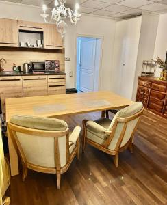 a kitchen with a wooden table and two chairs at Apartment 2 in Stockach