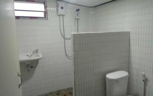 a bathroom with a shower and a toilet and a sink at Chicago lanta in Phra Ae beach