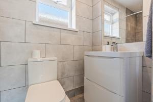 a white bathroom with a toilet and a sink at Long-Stay Ready in NG13 Bungalow, sleeps 6 in Bingham +36 photos
