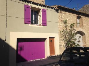 a building with purple doors and a window at La Maison de Noémie in Leucate +7 photos
