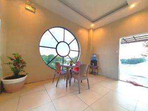 a dining room with a table and a round window at Spiral Suites Hotel in Manila