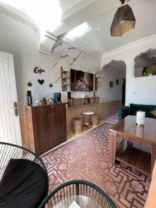 a living room with a table and a dining room at Youness House in Aourir
