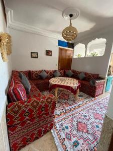 a living room with a couch and a table at Youness House in Aourir