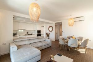 a living room and dining room with a couch and a table at Star Lit Jacuzzi Apartment in Câmara de Lobos
