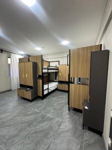 an empty room with bunk beds and wooden cabinets at Art City Hostel in Salor Bekati