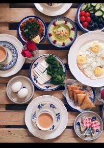 a wooden table with plates of breakfast food on it at Rum STAR luxury camp in Wadi Rum