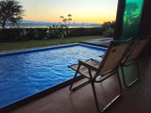 a chair sitting next to a swimming pool at Sunrise Resort & Cafe - ซันไรส์ รีสอร์ท & คาเฟ่ in Nakhon Phanom