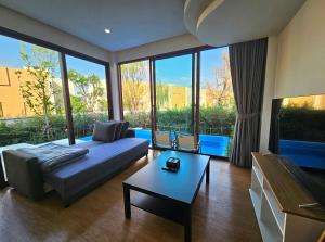 a living room with a couch and a table at Sunrise Resort & Cafe - ซันไรส์ รีสอร์ท & คาเฟ่ in Nakhon Phanom +27 photos