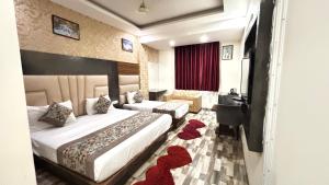 a hotel room with a large bed and a desk at Smart Plaza Hotel-Free One Way Airport Pickup Or Drop in New Delhi +27 photos