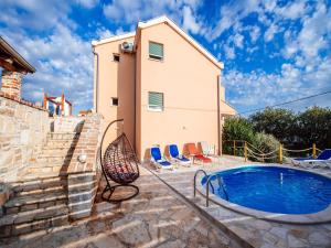 a villa with a swimming pool and a house at Holiday Home Jasenice near Beach & Pool in Maslenica