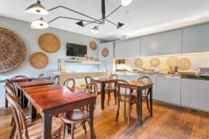 a kitchen and dining room with tables and chairs at Casa dos Lóios by Shiadu in Porto +61 photos