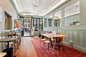 a restaurant with tables and chairs and a rug at Casa dos Lóios by Shiadu in Porto