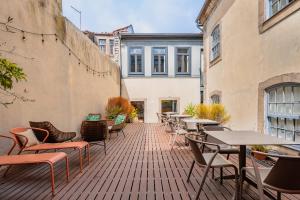 a patio with tables and chairs on a building at Casa dos Lóios by Shiadu in Porto