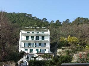 a white building on the side of a hill at Villa Delle Rose in Noli