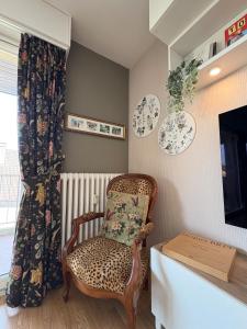 a room with a chair and plates on the wall at Entre Lac, Fleurs et Montagnes in Thonon-les-Bains +6 photos