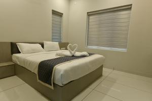 a bedroom with a bed with a blanket and a window at Star Guest House 