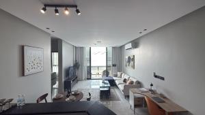 a living room with a couch and a table at Suites OrbitNet Khobar in Dammam