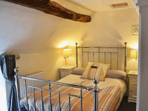 a bedroom with a bed in a room at Post Office Cottage in Highpeak Junction