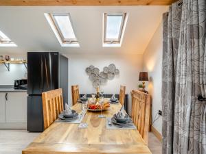 a kitchen and dining room with a table and a black refrigerator at Briar Cottage in Great Eccleston +19 photos