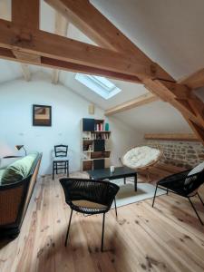 a living room with black chairs and a couch at Le Clos d'Aboulin in Saint-Christophe-dʼAllier +18 photos