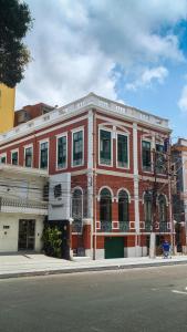 a red brick building on the corner of a street at JUNGLE STATION - Hostel in Belém +5 photos