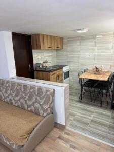 a kitchen and dining room with a table and chairs at Šumski mir in Despotovac