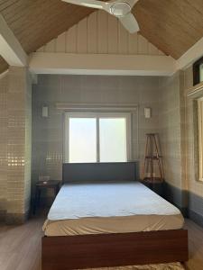 a bedroom with a bed with a ceiling fan at The Rock of Ages Resort 