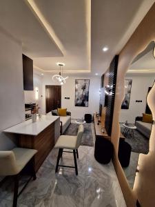 a kitchen and living room with a couch and a table at Cozy 1 Bedroom Studio Apartment in a Gated Estate in Lagos