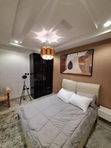 a bedroom with a large white bed in a room at Cozy 1 Bedroom Studio Apartment in a Gated Estate in Lagos