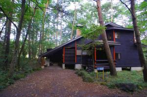 a blue house in the middle of the forest at HARUNA WING - Vacation STAY 26974v in Tsumagoi