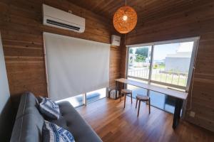 a living room with a couch and a table with a large window at Haruhiya in Ishigaki Island