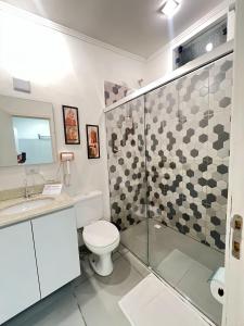 a bathroom with a toilet and a glass shower at Casa e Negócios in Mairiporã