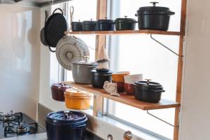 a shelf with pots and pans on it in a kitchen at Haruhiya in Ishigaki Island